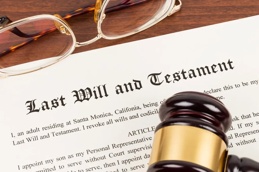 Last Will and Testament document in a table with a wooden gavel and a pair of eyeglasses.