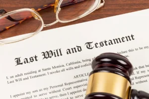 Last Will and Testament document in a table with a wooden gavel and a pair of eyeglasses.