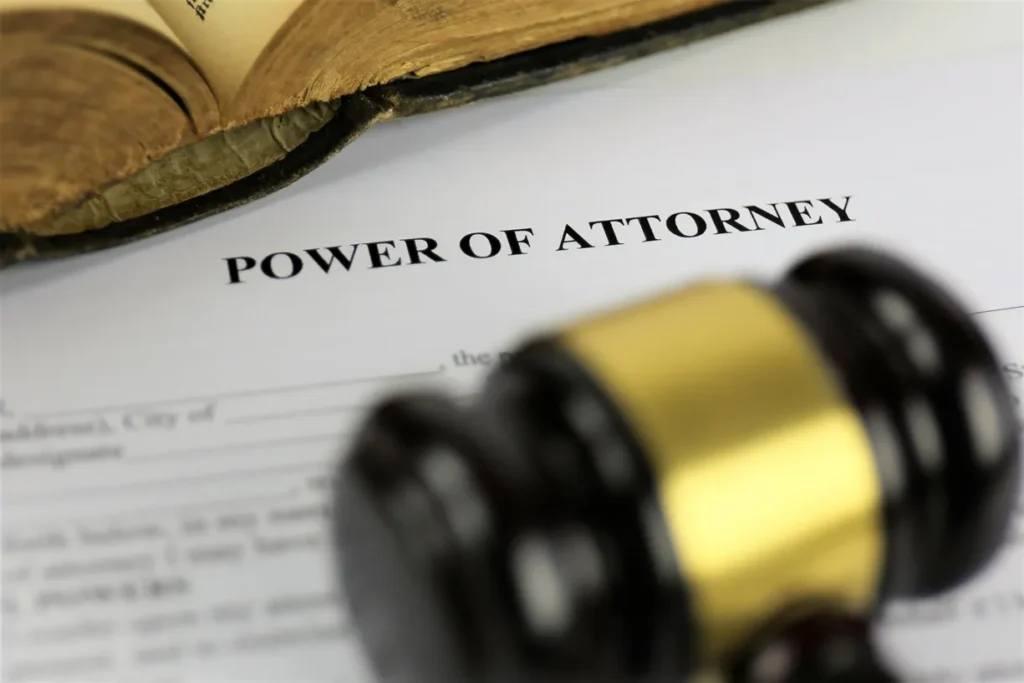 A power of attorney document with a wooden gavel resting on top.