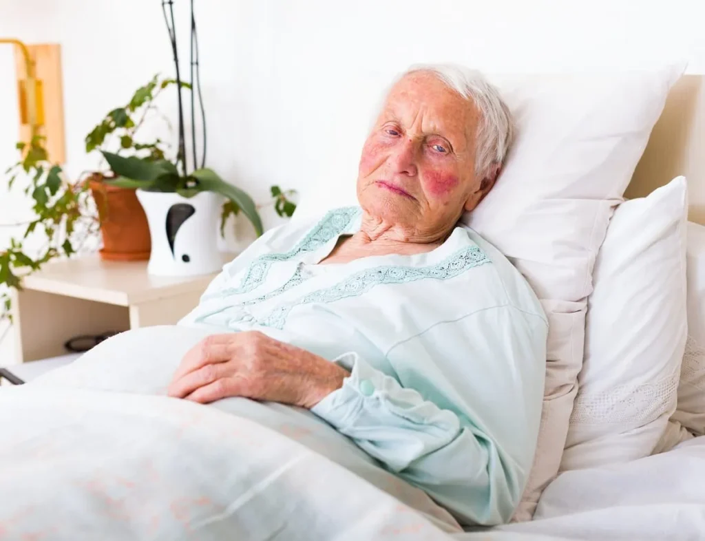An elderly women in bed.