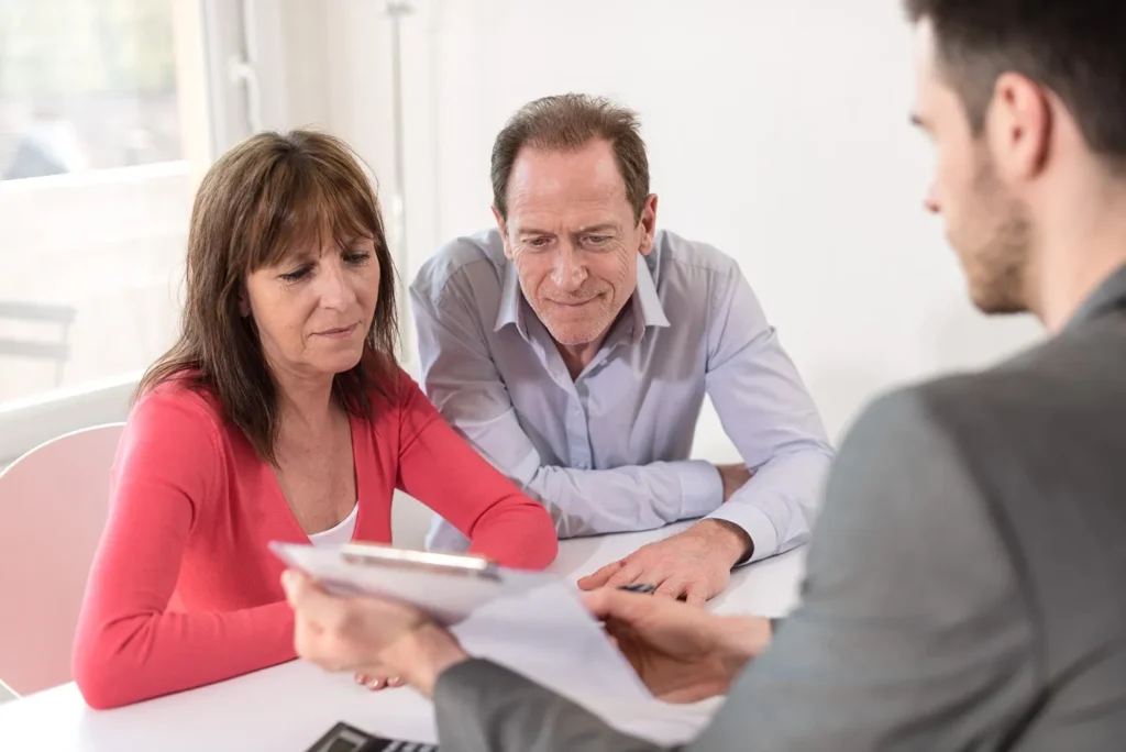 Couple reviewing options for removing an executor during a legal consultation.